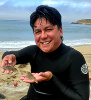 Ambrosio after diving, holding two fish